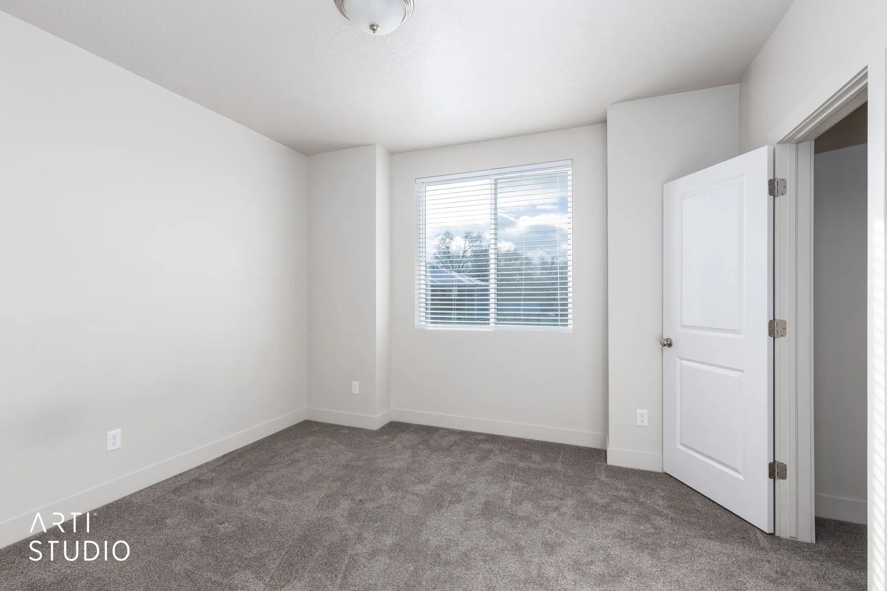 Carpeted empty room featuring baseboards