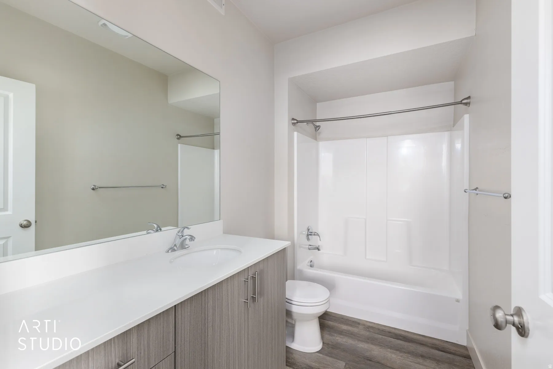 Full bathroom featuring shower / bathtub combination, vanity, and dark wood-type flooring
