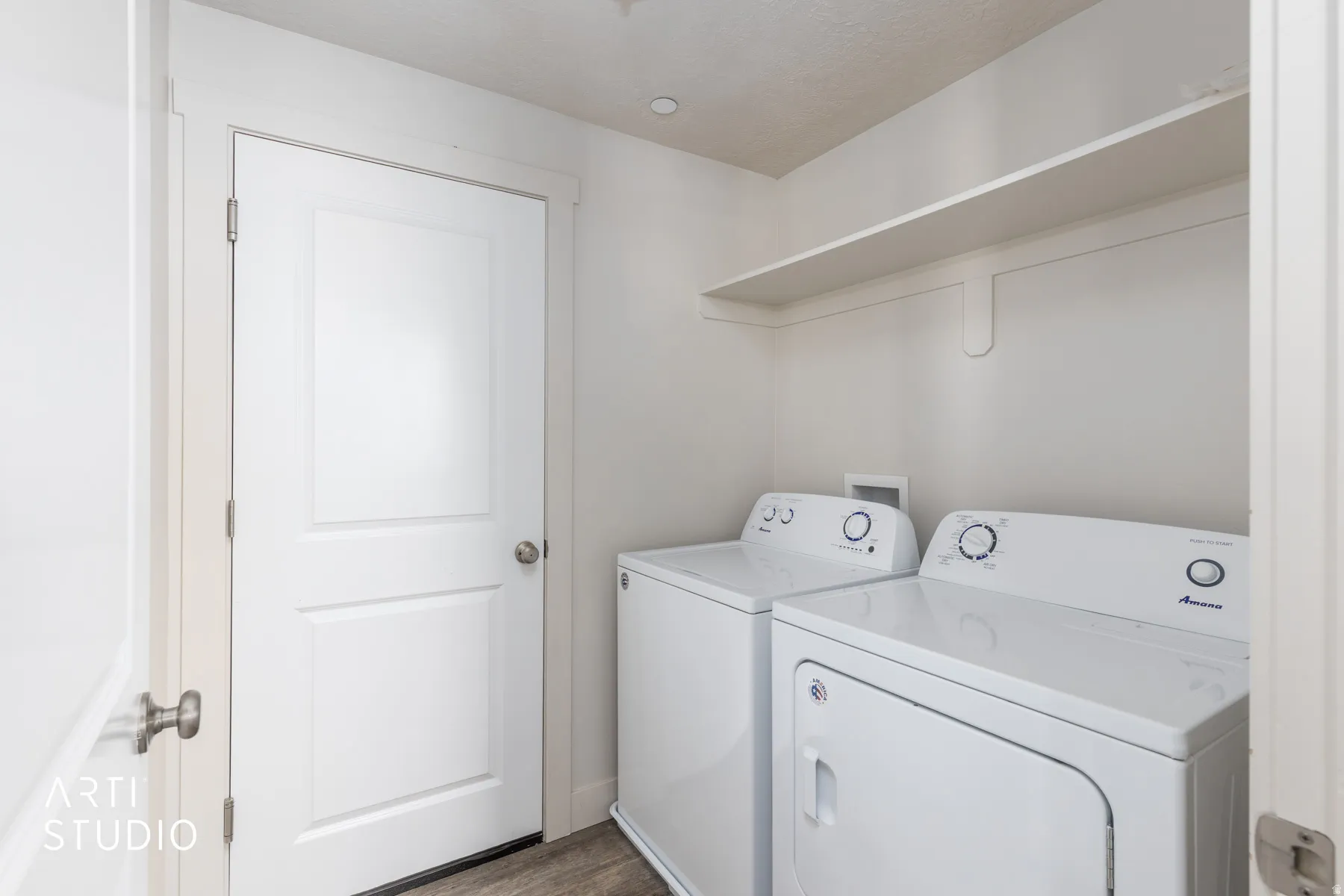 Laundry room featuring washing machine and clothes dryer and wood finished floors