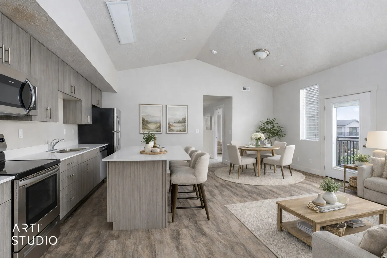 Kitchen featuring stainless steel appliances, a kitchen breakfast bar, a center island, open floor plan, and dark wood-type flooring