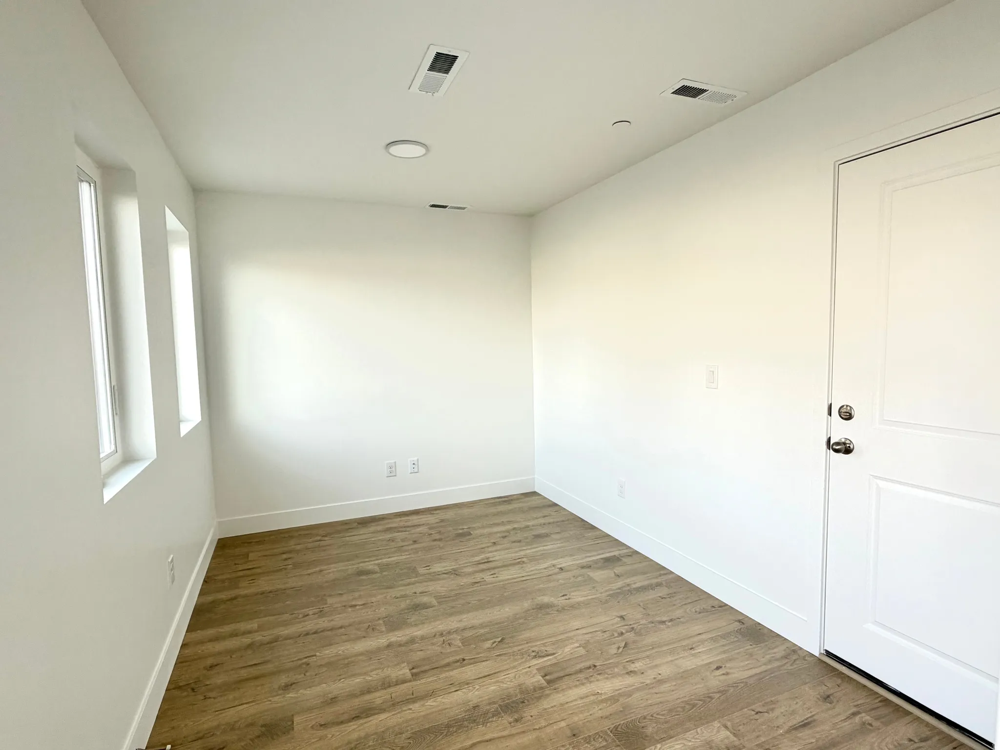 Empty room featuring wood finished floors and baseboards
