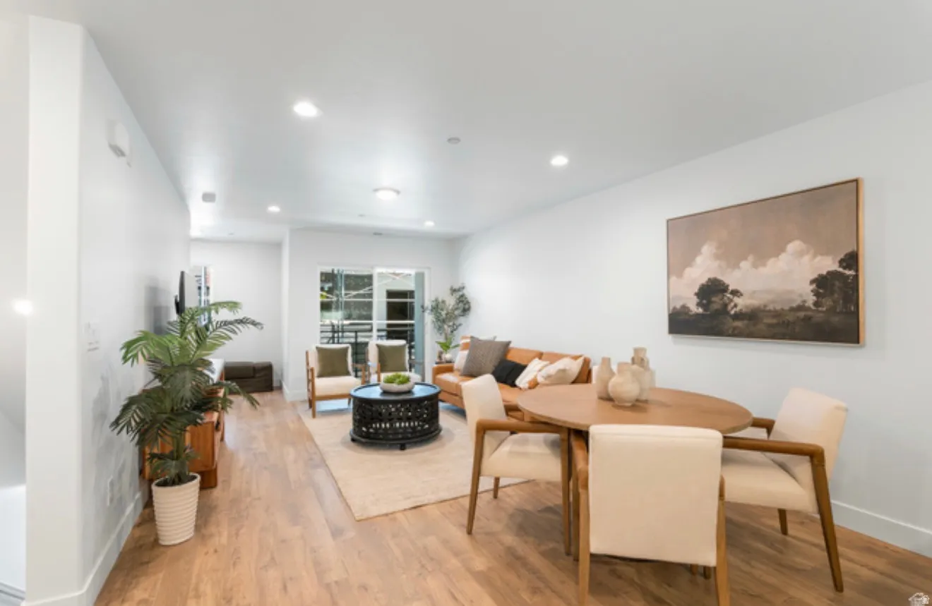 Dining area with wood finished floors and recessed lighting
