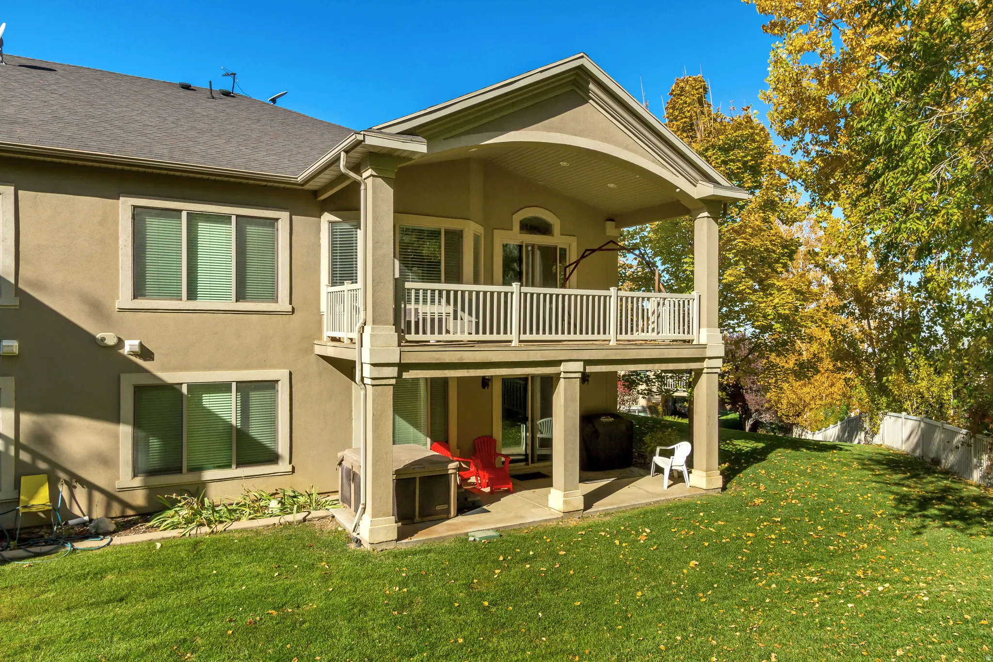 Back of house with a patio, stucco siding, and a shingled roof