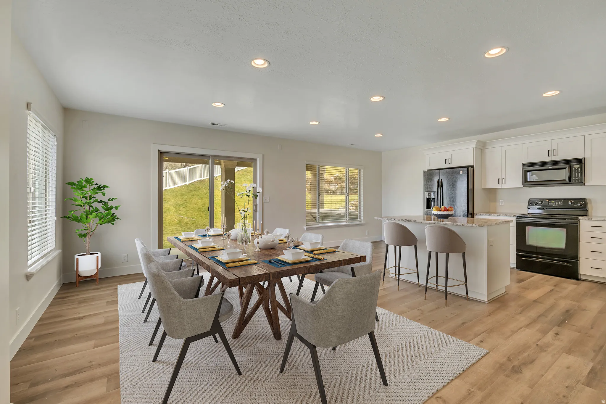 Dining area with recessed lighting and light wood-style floors