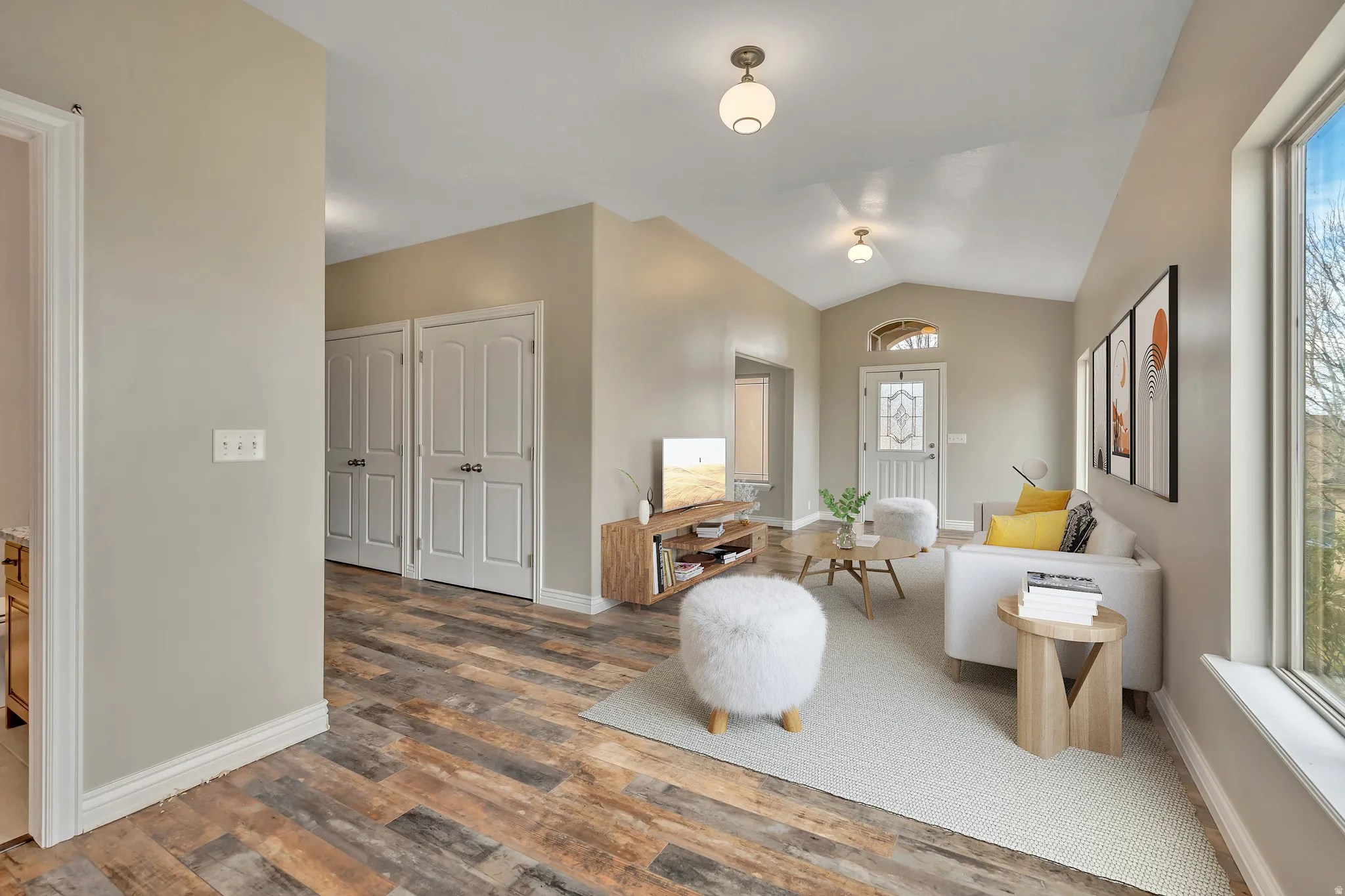 Living area featuring vaulted ceiling and wood finished floors