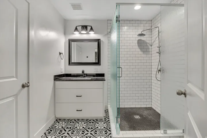 Bathroom featuring vanity, a shower stall, and light tile patterned flooring