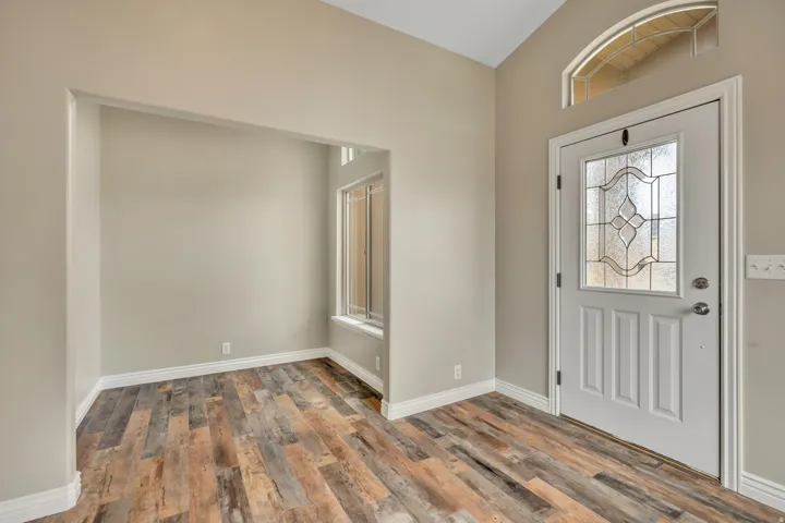 Foyer featuring wood finished floors and baseboards