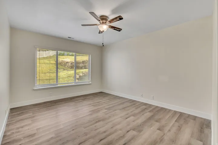 Spare room featuring light wood-style floors and ceiling fan