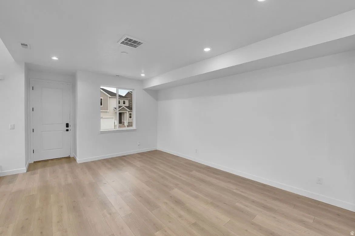 Spare room featuring light wood finished floors and recessed lighting