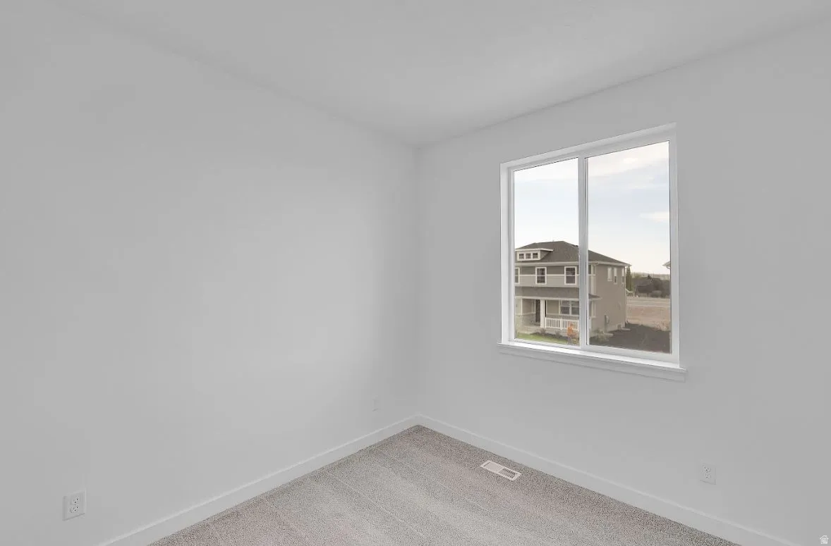 Unfurnished room with light carpet and baseboards