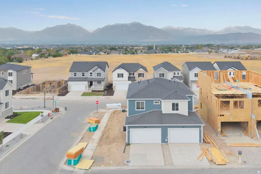 Aerial perspective of suburban area with a mountainous background