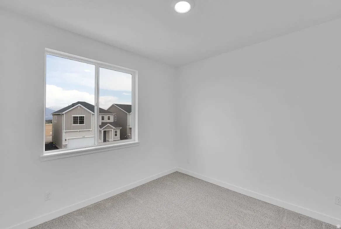 Spare room with baseboards and carpet