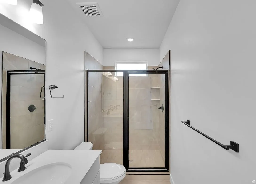 Bathroom with vanity and a shower stall