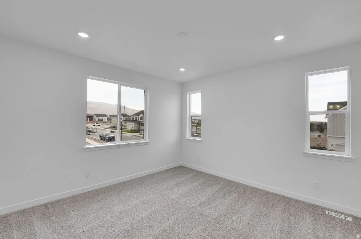 Empty room featuring light carpet and recessed lighting