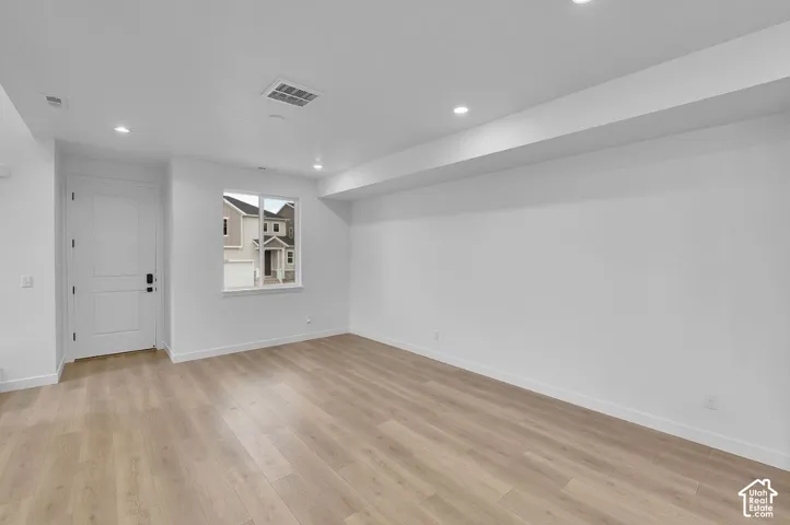 Spare room featuring light wood finished floors and recessed lighting