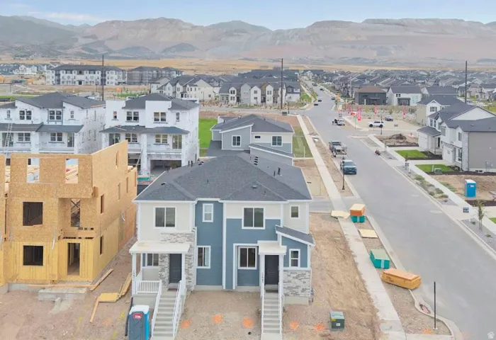 Aerial perspective of suburban area with a mountainous background