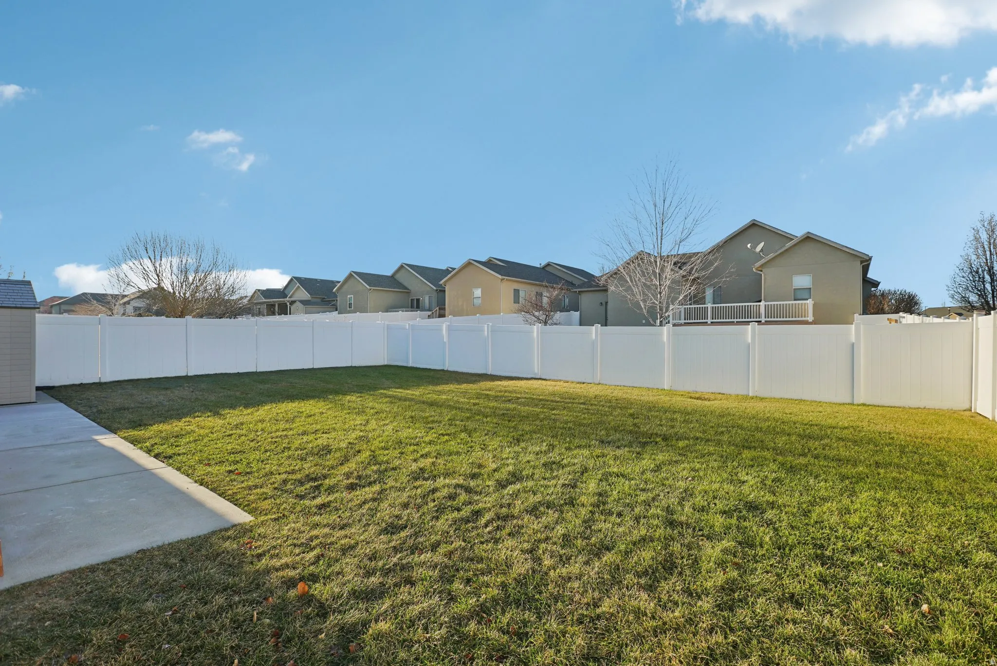 Fenced backyard featuring a residential view