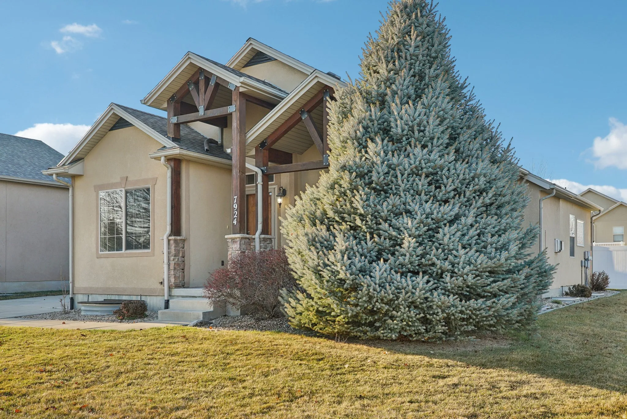 View of front of home featuring a front lawn and stucco siding
