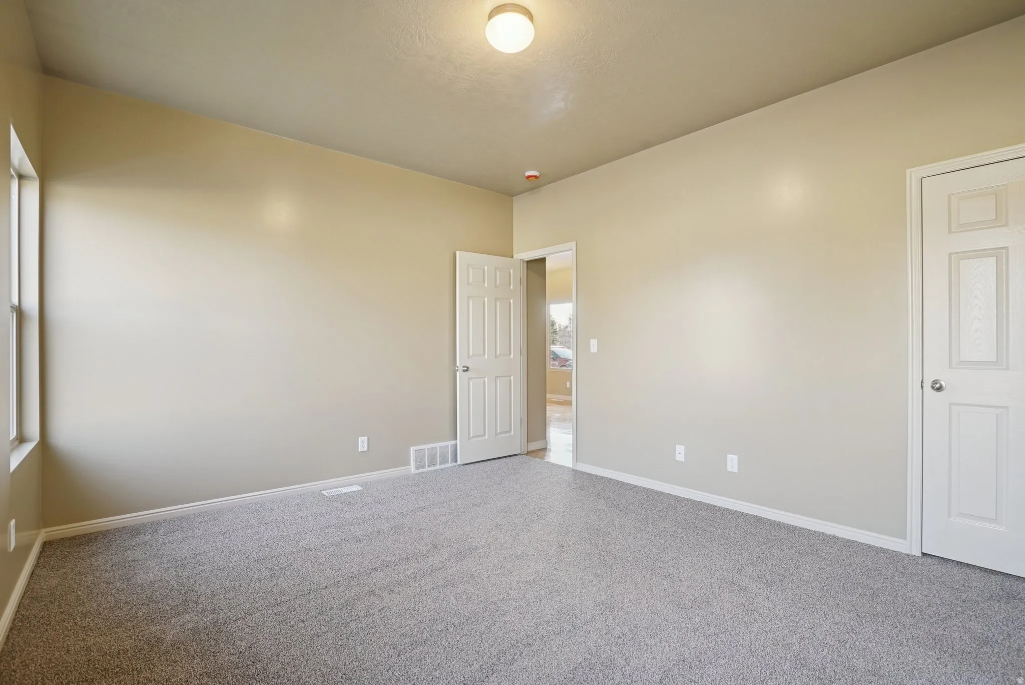 Empty room featuring carpet and baseboards