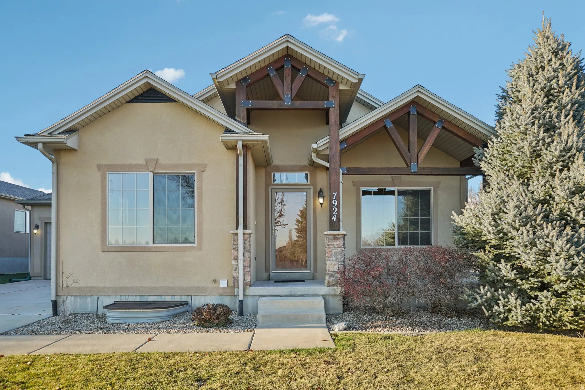 View of front of property with stucco siding and a front lawn