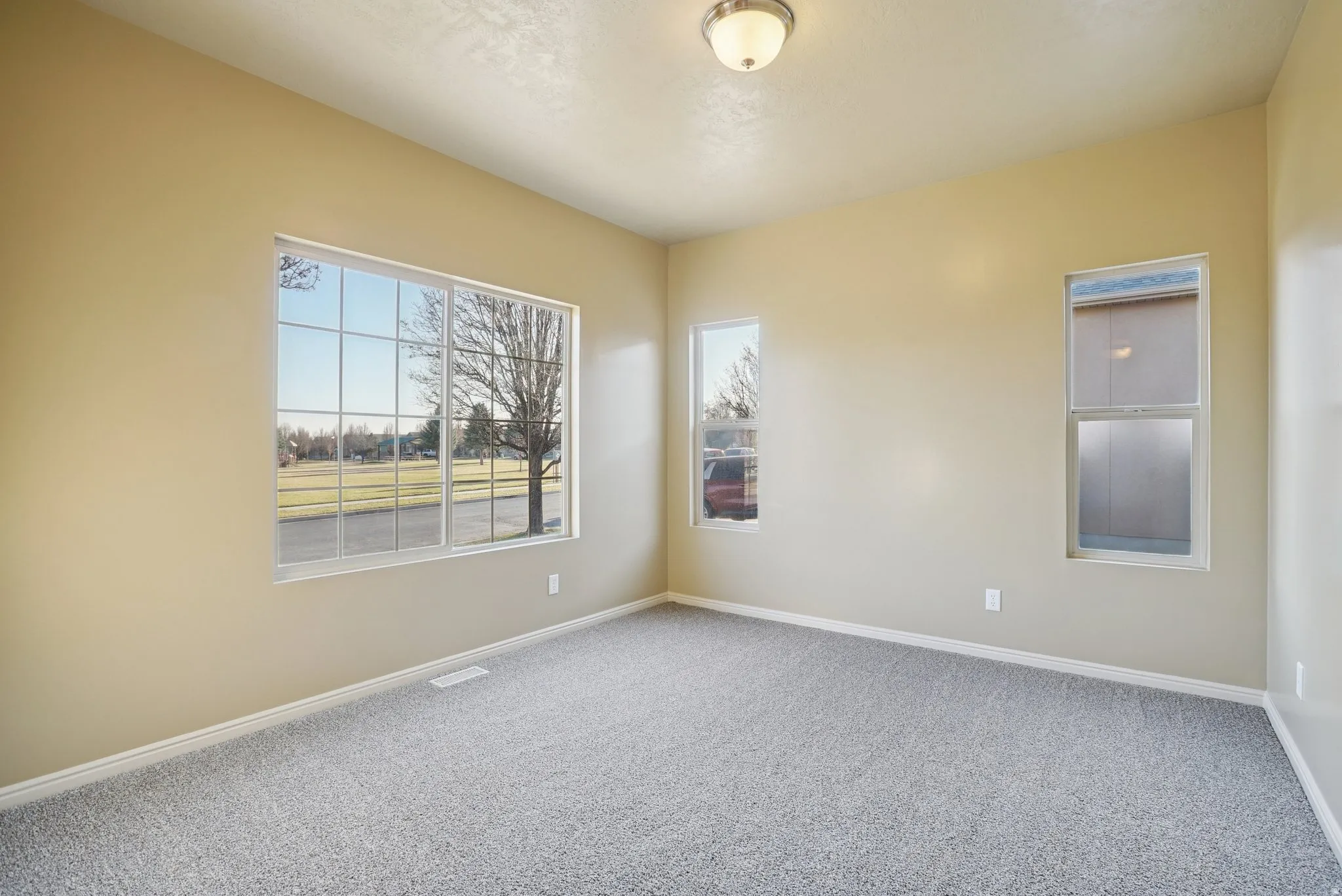 Spare room featuring baseboards and carpet floors