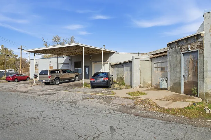 View of parking with a garage and a carport