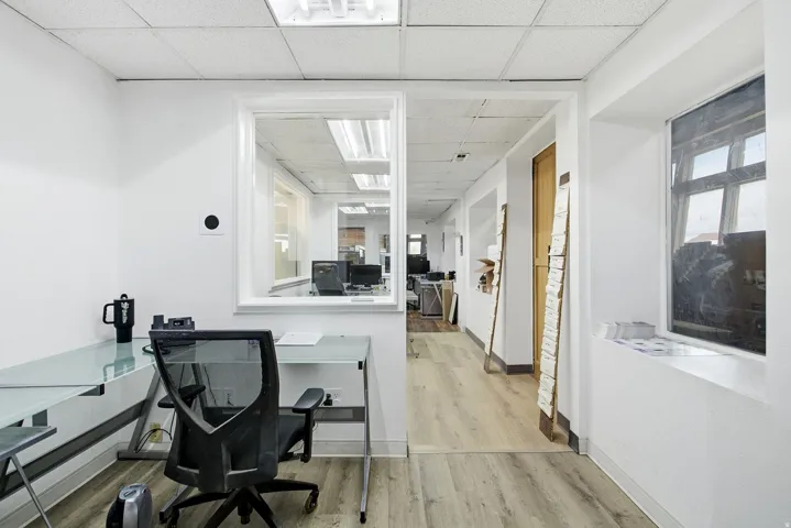 Office area featuring a drop ceiling and light wood finished floors