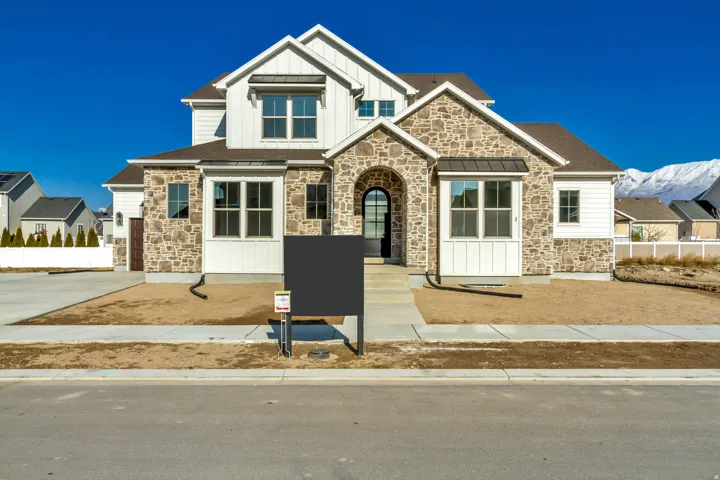 Craftsman-style house featuring stone siding and board and batten siding