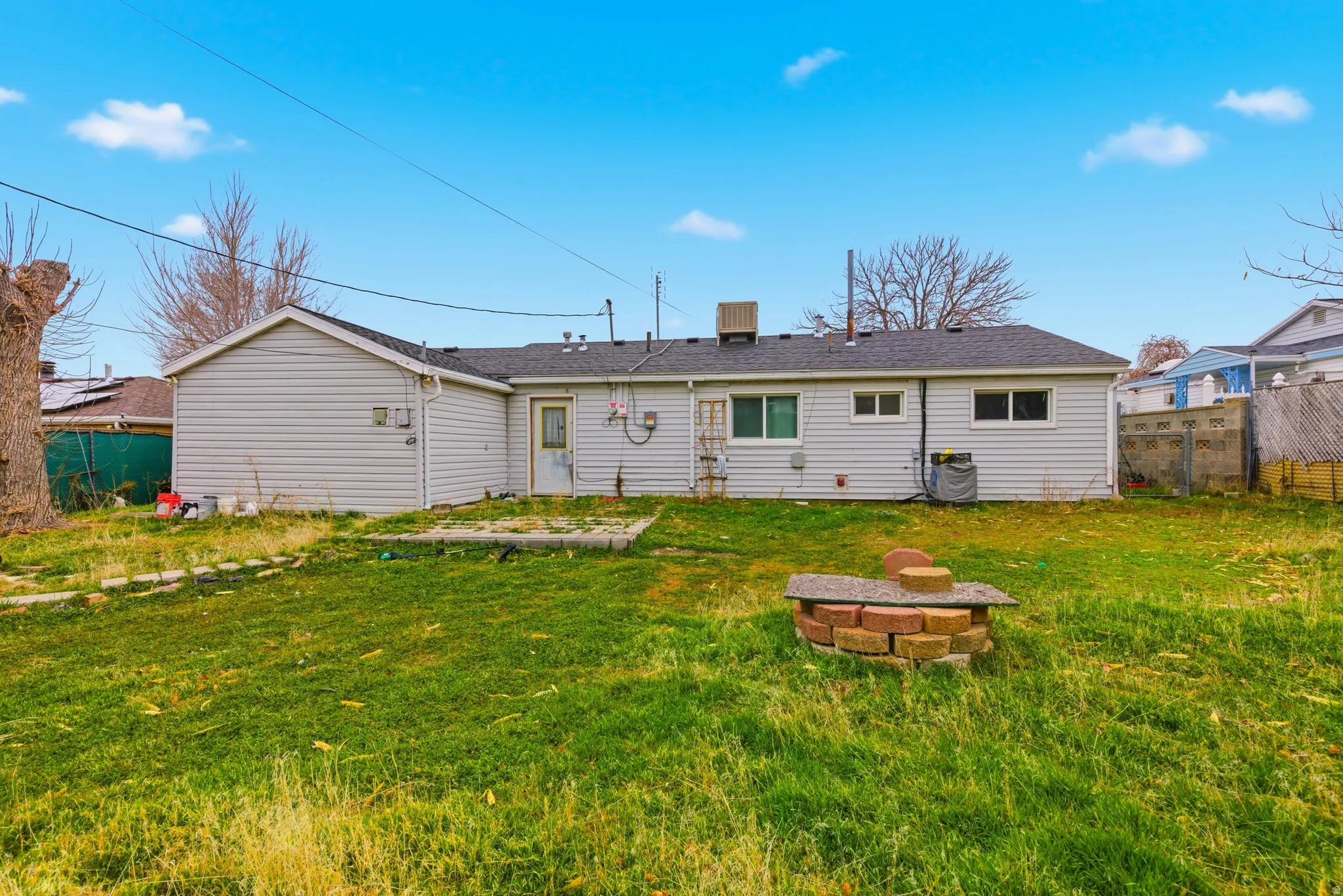 Back of property featuring a fire pit