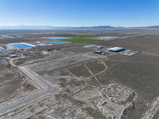 Aerial view of property's location featuring a mountainous background