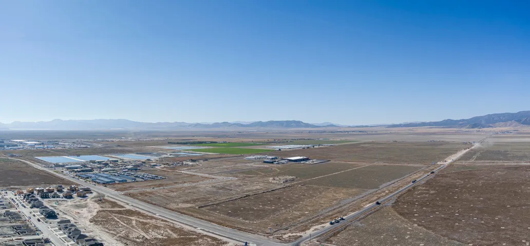 Aerial view of a mountain backdrop and an industrial area