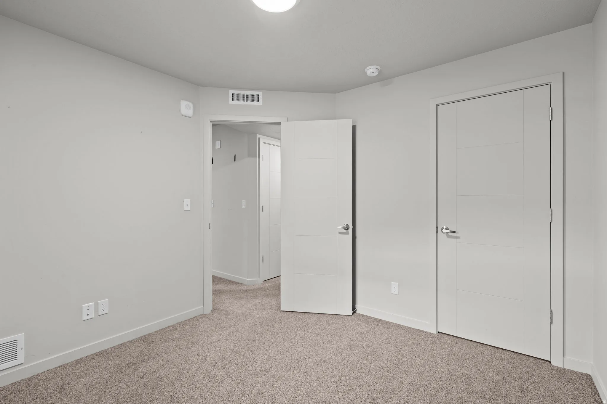 Unfurnished bedroom with carpet flooring and baseboards