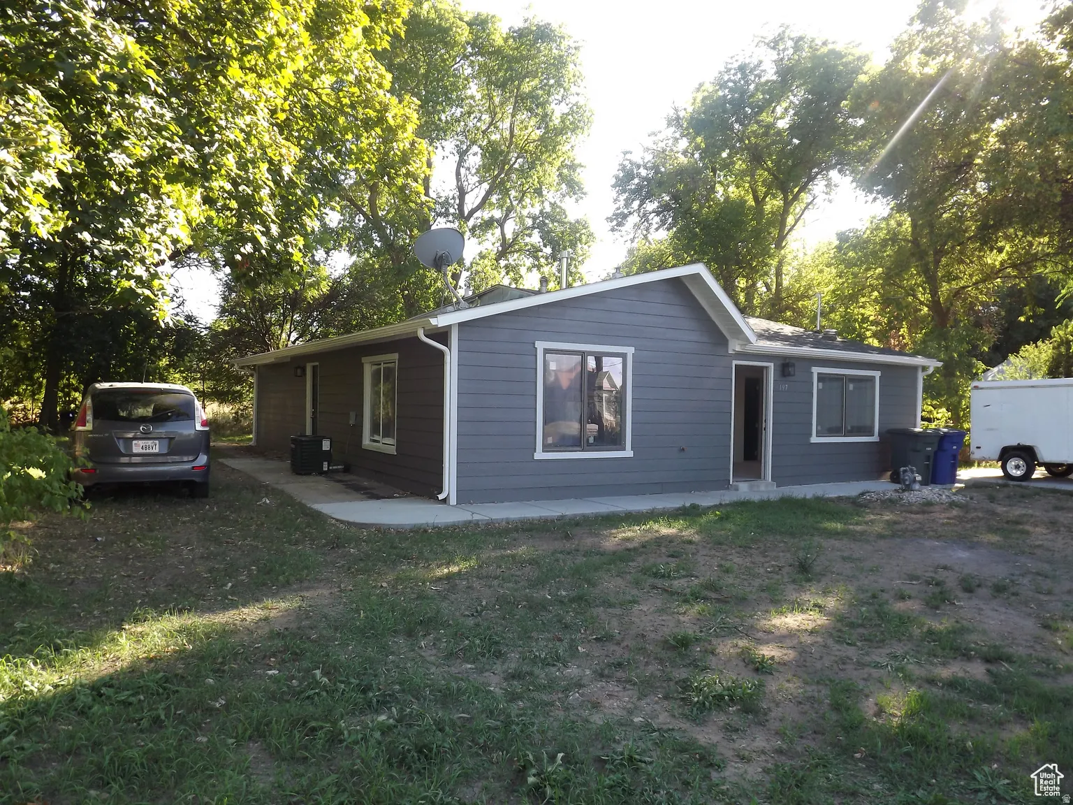 Front/side view of property with a yard