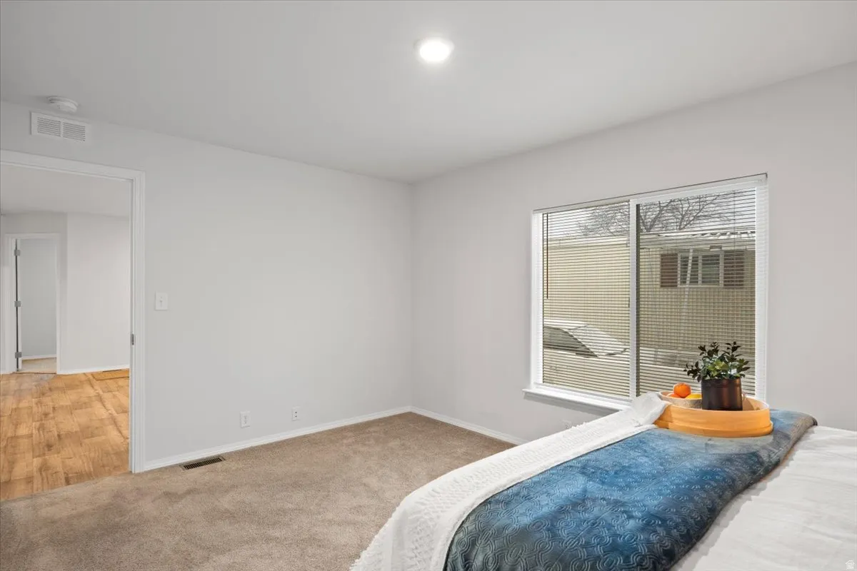 Carpeted bedroom featuring baseboards