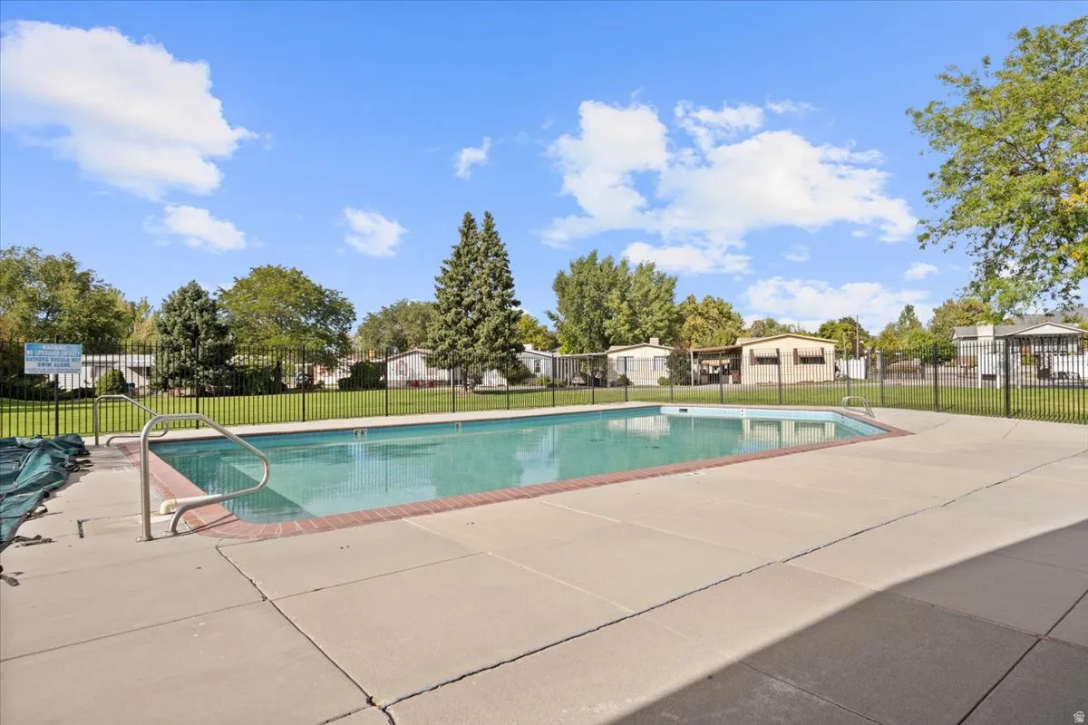 Community pool with a patio