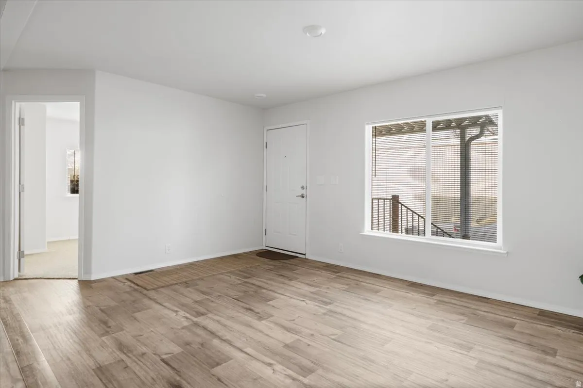 Empty room featuring light wood-style flooring and baseboards