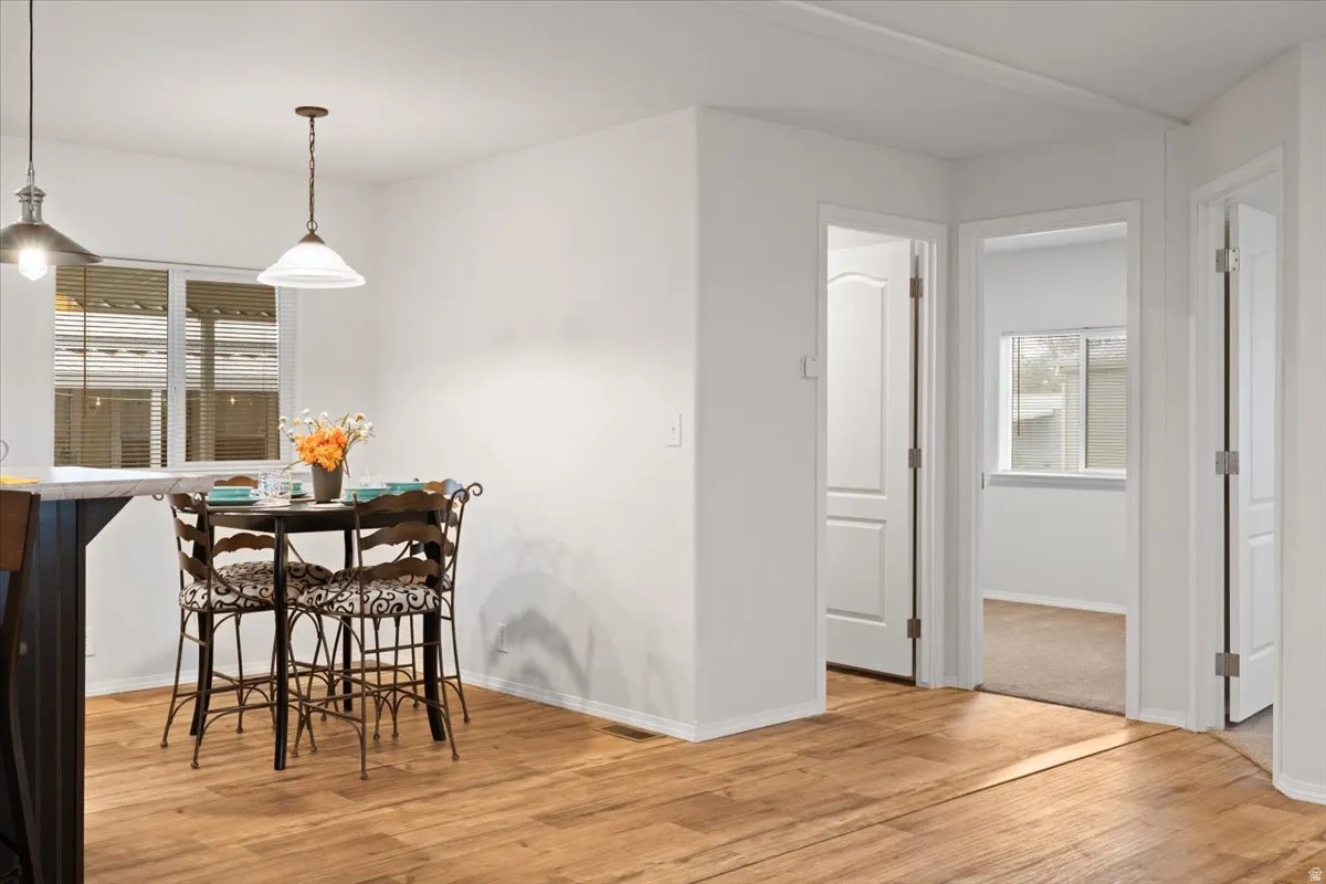 Dining space with light wood-type flooring and baseboards