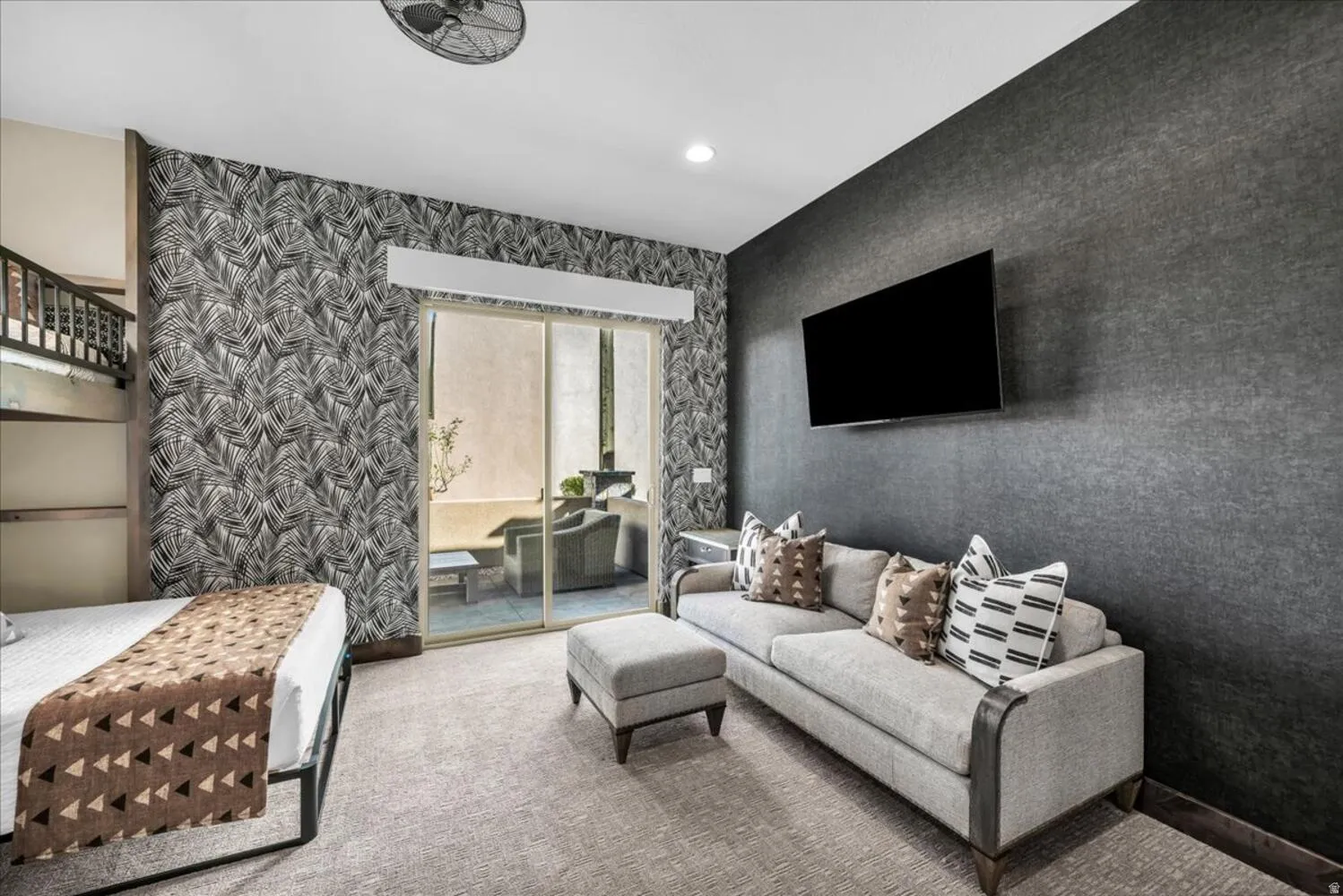 Living room with wallpapered walls, carpet flooring, and recessed lighting