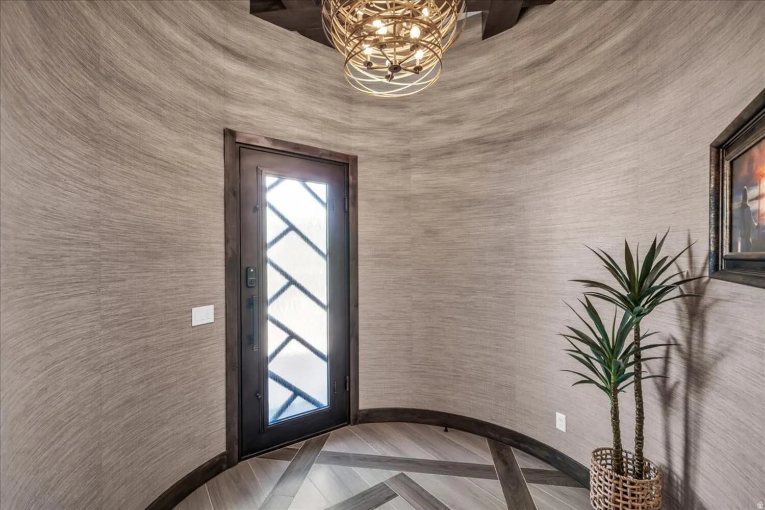 Entryway with a chandelier and wallpapered walls