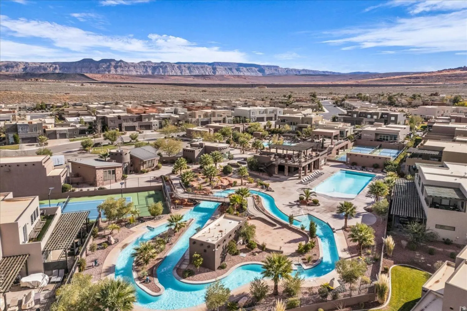 Aerial view of residential area with a pool area and a mountain backdrop