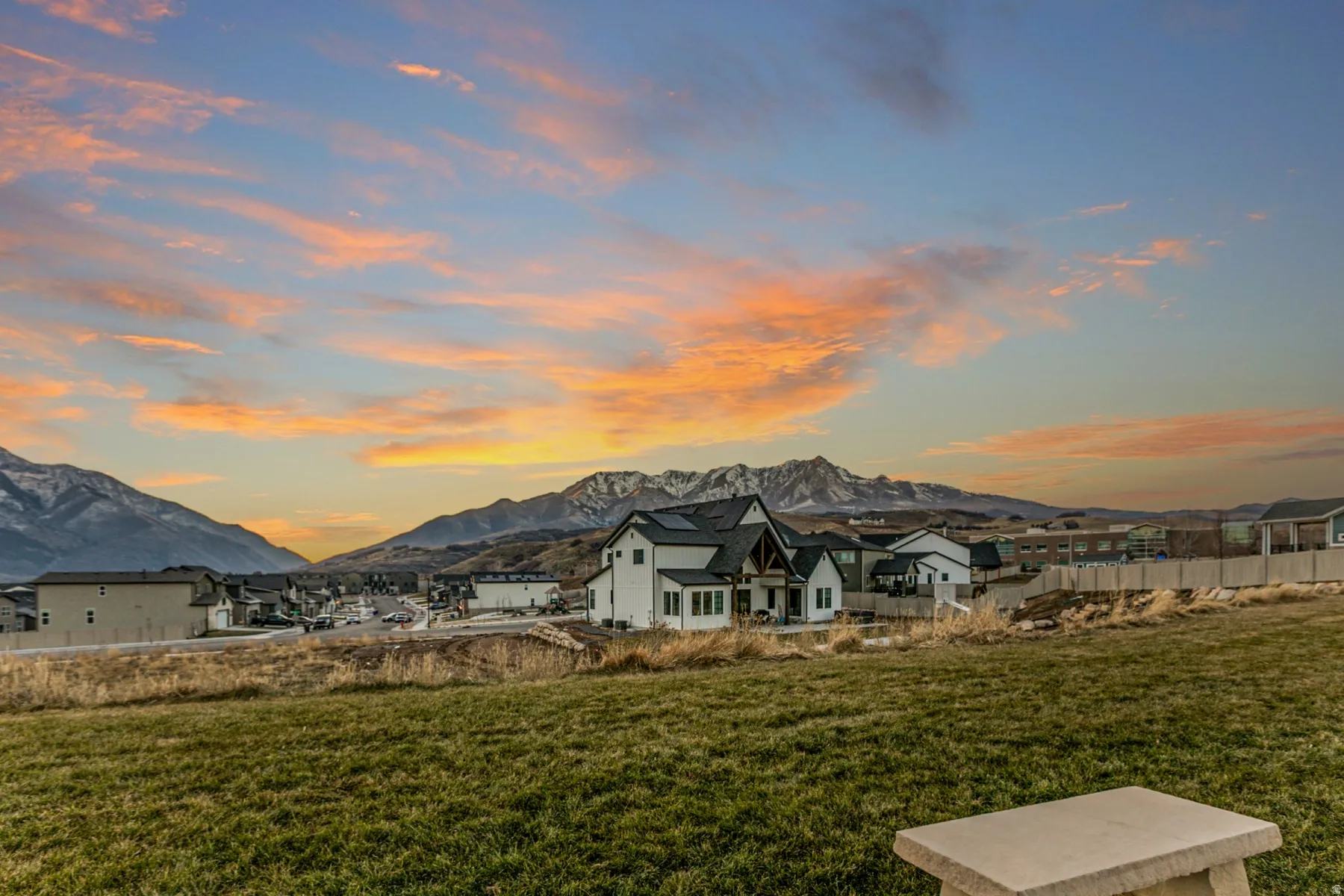 Back of property featuring a mountain view and a patio area