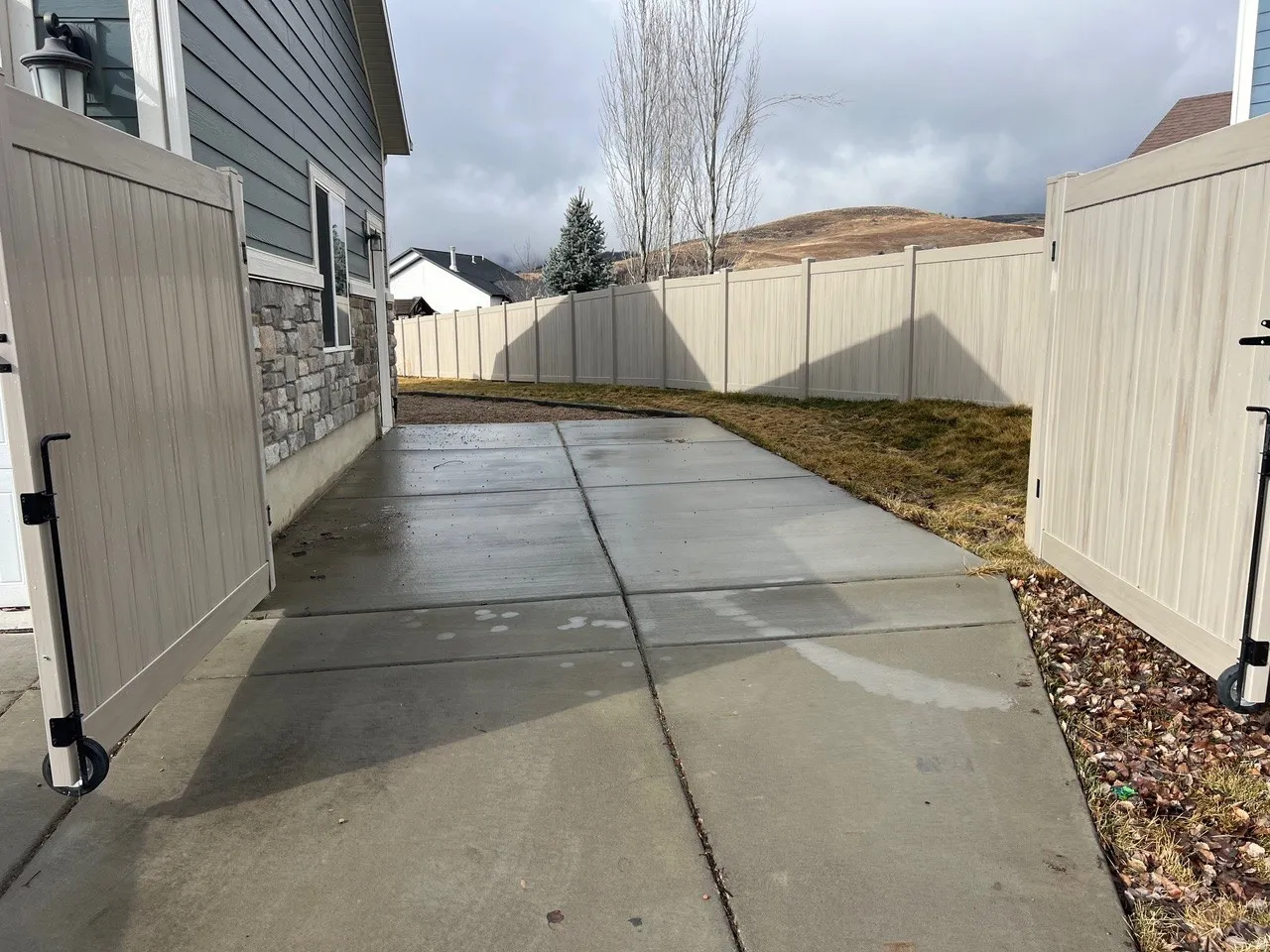 Fenced backyard with a patio area