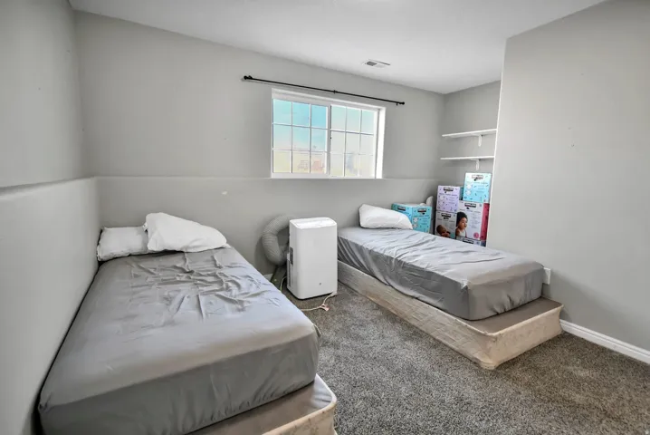 Bedroom featuring carpet floors and baseboards