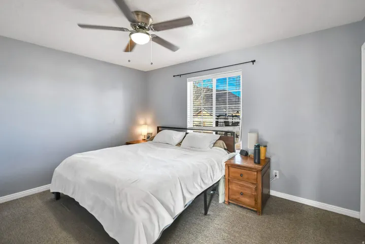 Bedroom with a ceiling fan and carpet floors