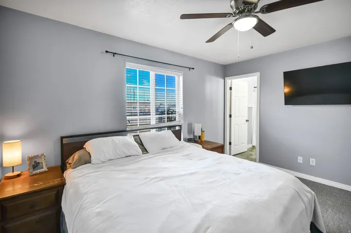 Bedroom with ceiling fan and carpet