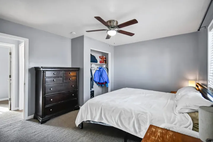 Bedroom featuring carpet flooring, a ceiling fan, and a closet