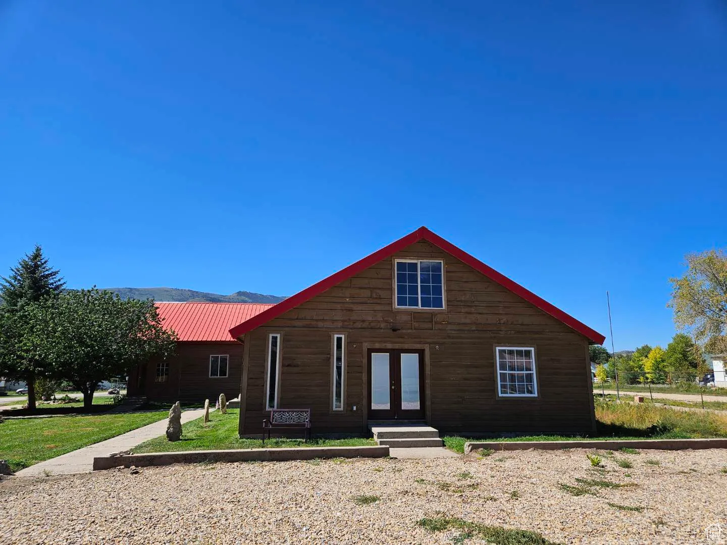 View of front facade featuring french doors and a metal roof