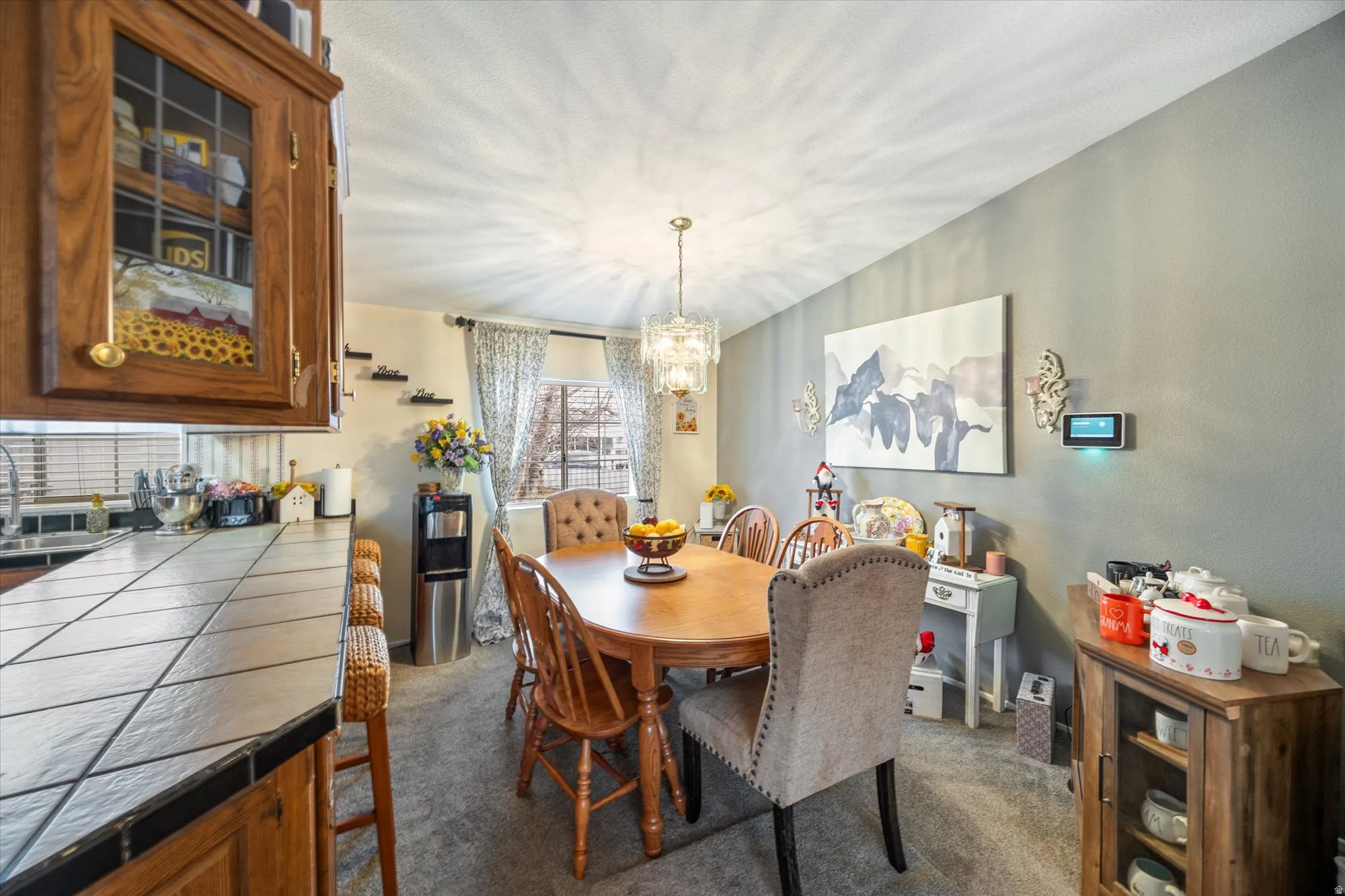 Dining room with a chandelier and dark carpet