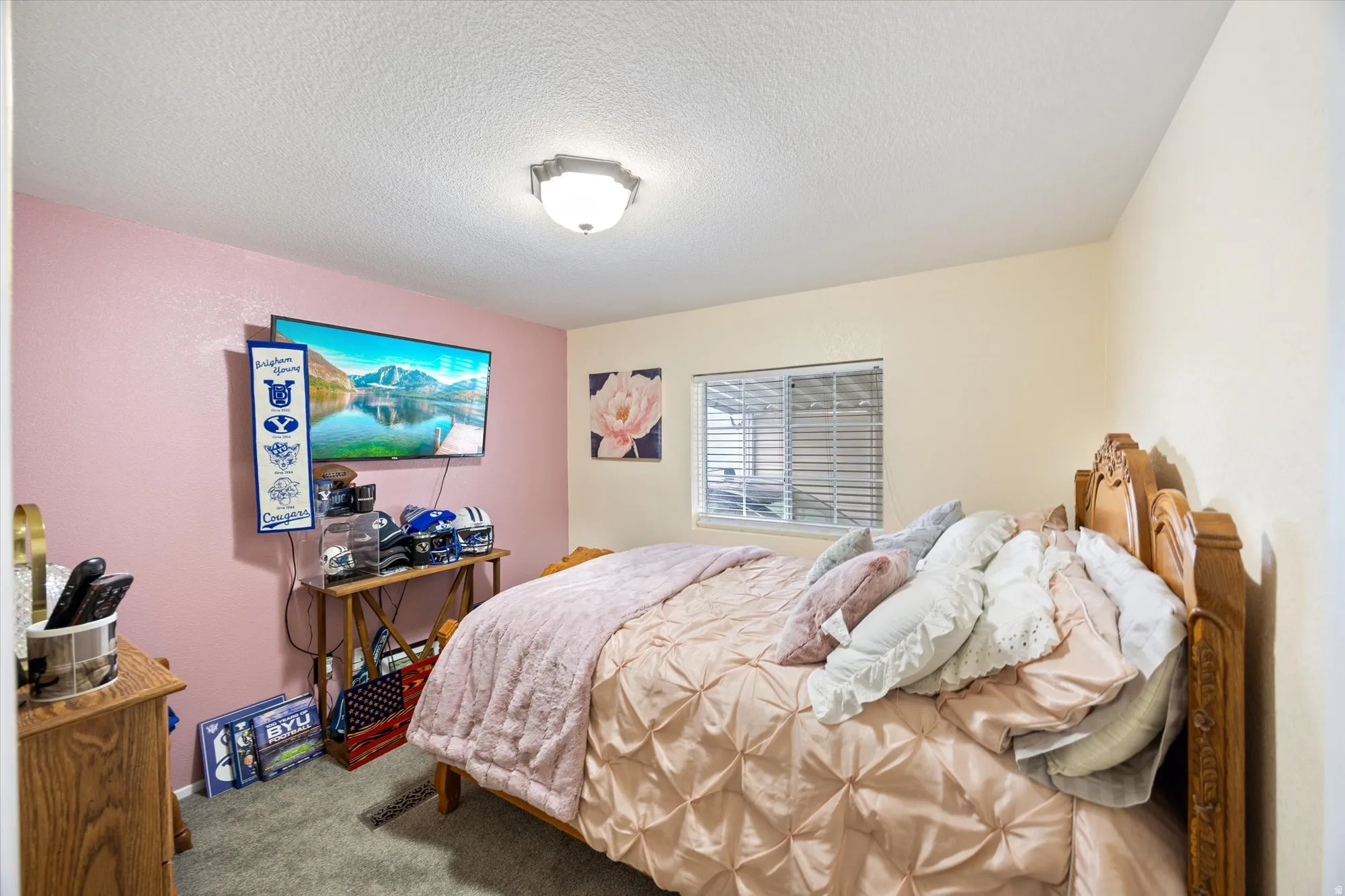 Bedroom featuring a textured ceiling and carpet