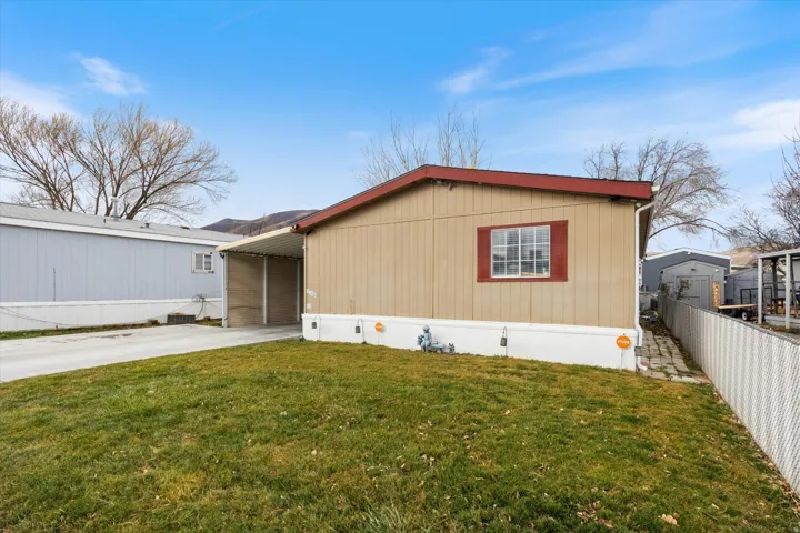 View of front of property with driveway and a carport